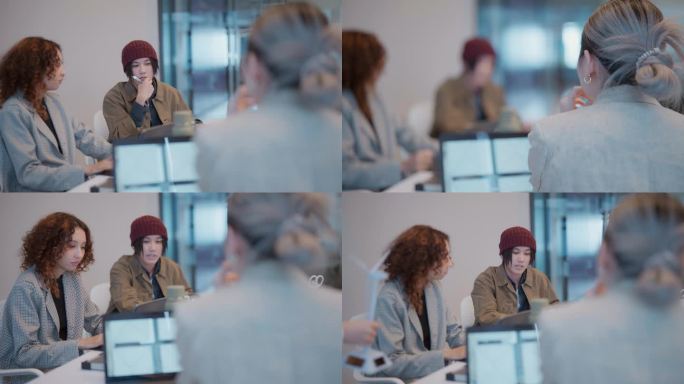 女经理在创业会议办公室用笔记本电脑和团队讨论项目的后视图