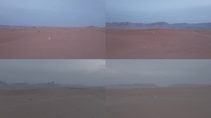 阿拉伯人独自走在广阔沙漠中