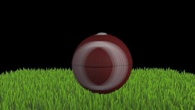 美式足球在绿草地上旋转