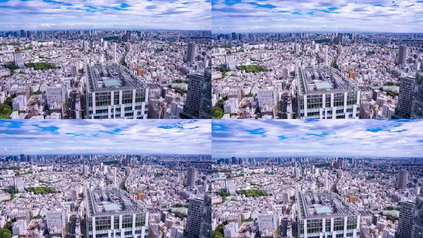 高宽倾斜延时东京城市天际线鸟瞰图与通过云在一个充满活力的一天