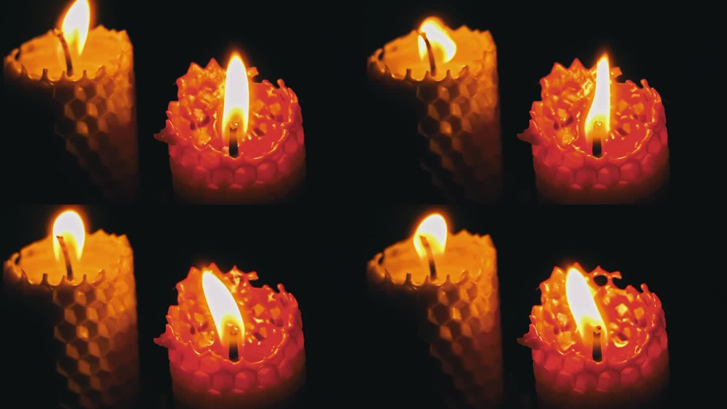 两支蜡烛在黑色背景上燃烧