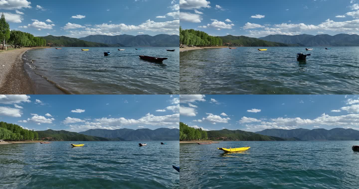航拍晴天泸沽湖上五彩的木船