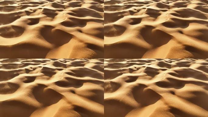 在突尼斯4K航拍镜头中，无人机俯视着撒哈拉沙漠，随着风吹过山丘和沙丘的沙子旋转