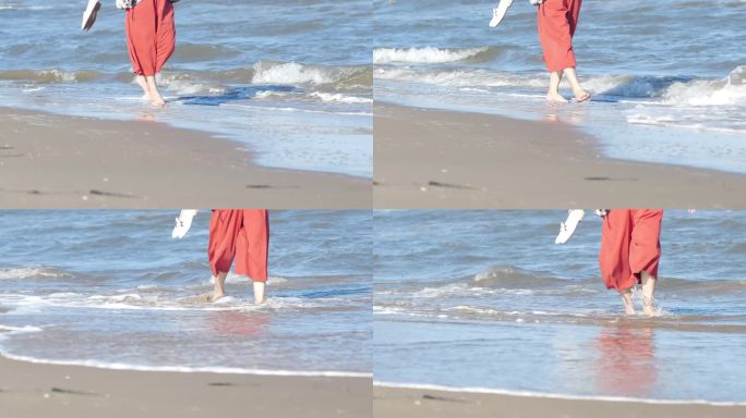 一个女人赤脚走在沙滩上。