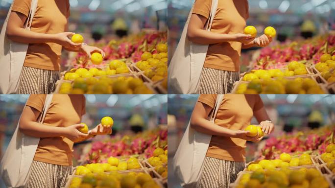 年轻女子选择在超市买水果。
