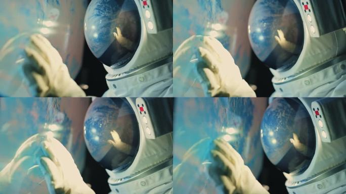 亚洲华裔中年女航天员在太空飞船上透过窗户看地球