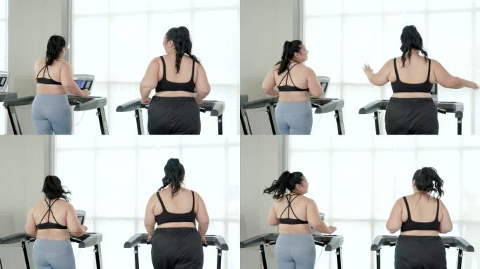 两个胖乎乎的亚洲女人穿着运动服站在跑步机后面。两个胖乎乎的女人都有强烈的减肥意愿、健身伙伴、生活方式