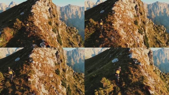 高角度无人机镜头确定男性山地自行车骑在草地悬崖在阳光明媚的一天