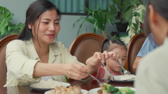 Closeup of Asian family eating chinese food and ha