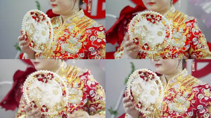 新娘手里的中式扇子秀禾服