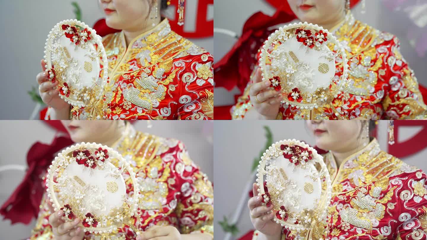 新娘手里的中式扇子秀禾服