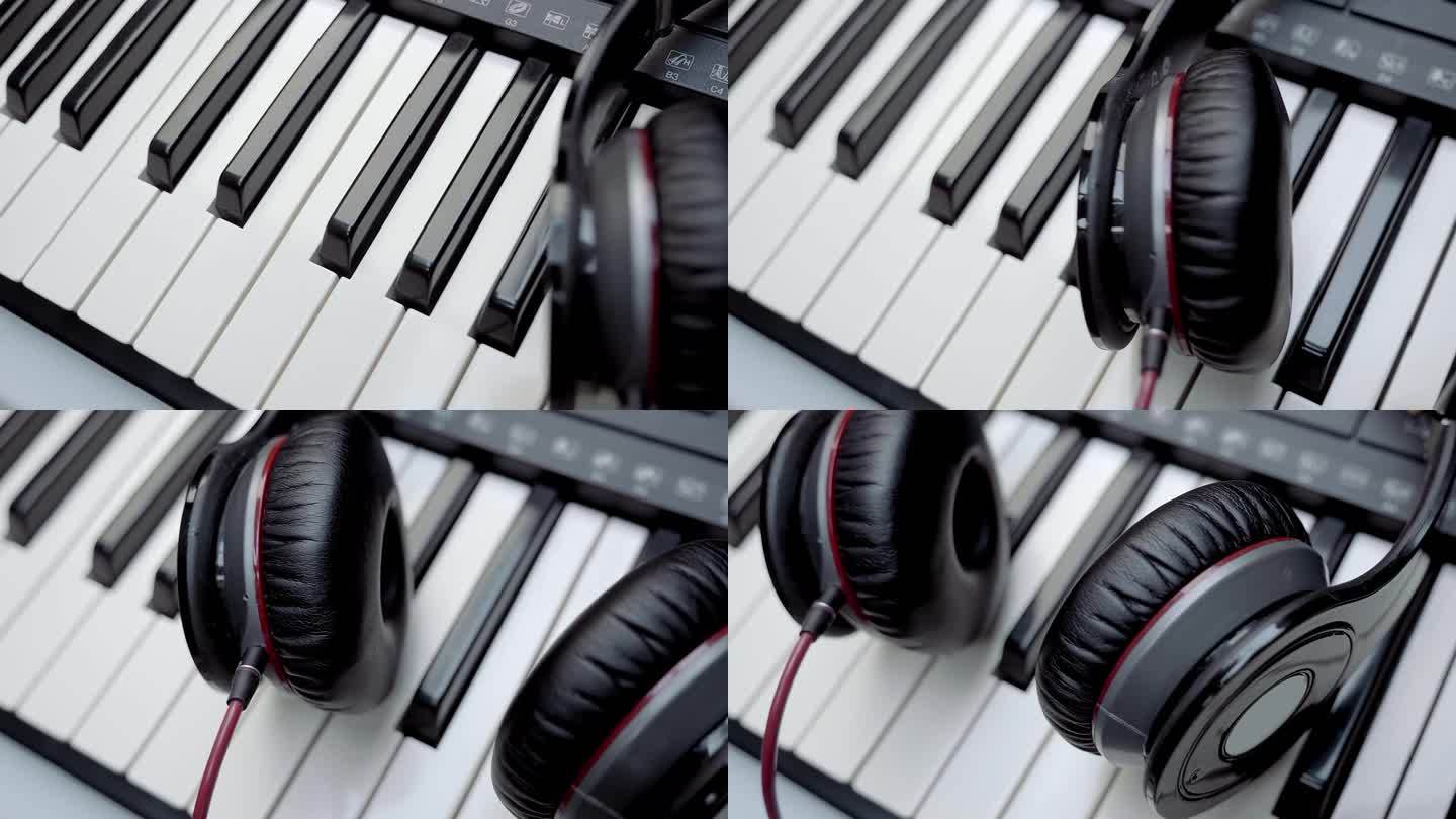 DJ(音乐家)的耳机放在合成器(钢琴)键盘上