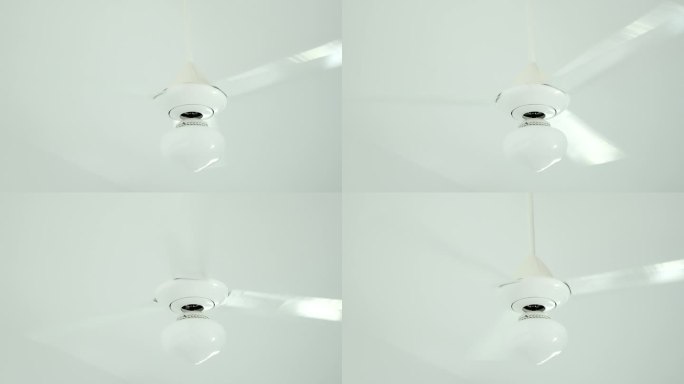 白色吊扇，3片叶片和灯旋转，冷却室内空气。闷热的夏天，家里没有空调