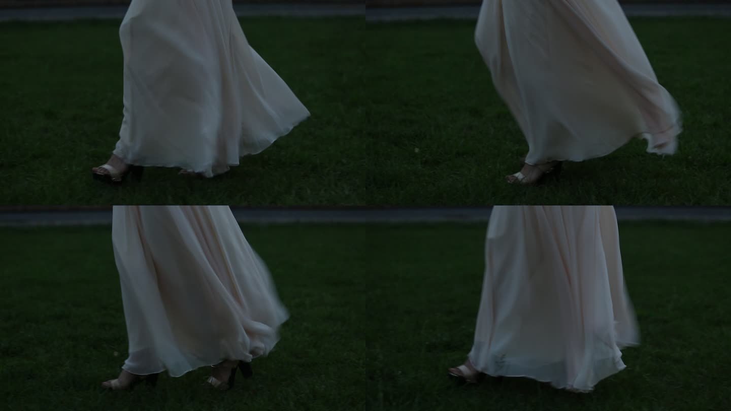 酒会穿着白裙子的女人站在草地上 微风徐徐