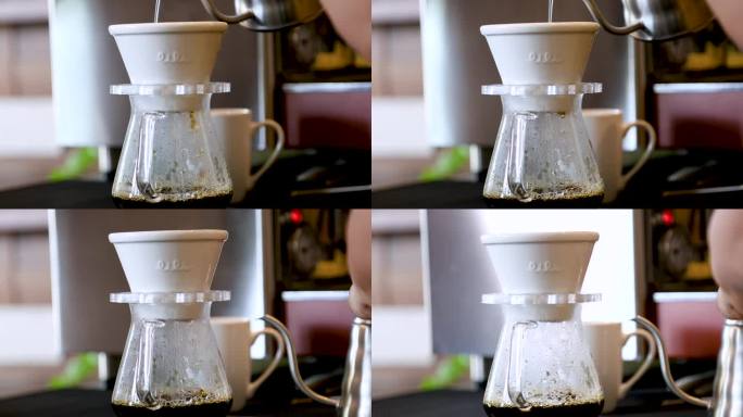 4k，咖啡点滴设备中压力豆粉的热咖啡水滴特写，上菜前手工将咖啡滴入玻璃杯的过程，咖啡点滴爱好者的生活