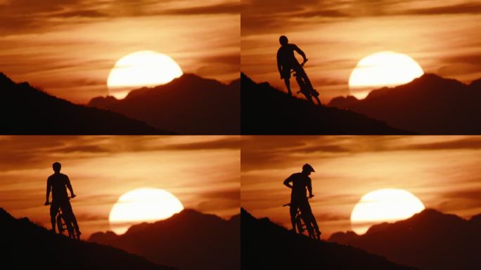 在日落期间，确定的剪影山地自行车手在戏剧性的天空下骑自行车下山的锁定镜头