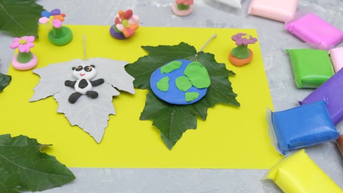 孩子们为地球日制作橡皮泥星球。保护环境，拯救地球。生态学的概念。