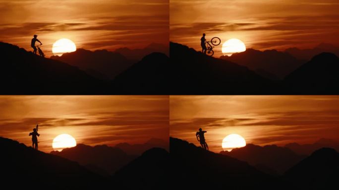 SLO MO锁定的剪影山地自行车手携带和推动自行车，而移动上山对抗戏剧性的橙色天空