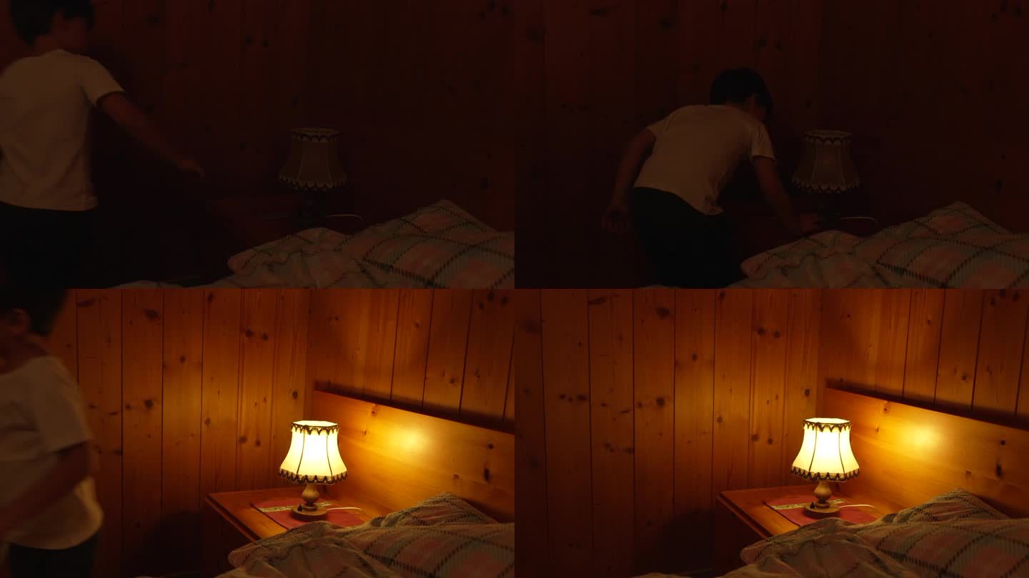 孩子在传统的木屋内部打开床头灯。一个小男孩打开传统的古董灯
