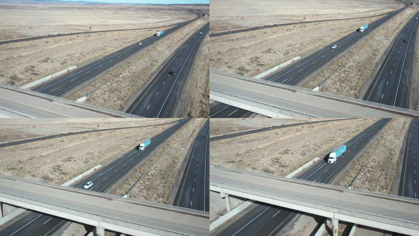 无人机拍摄的一辆白色半挂车在一个阳光明媚的冬日在犹他州I-70上向东行驶