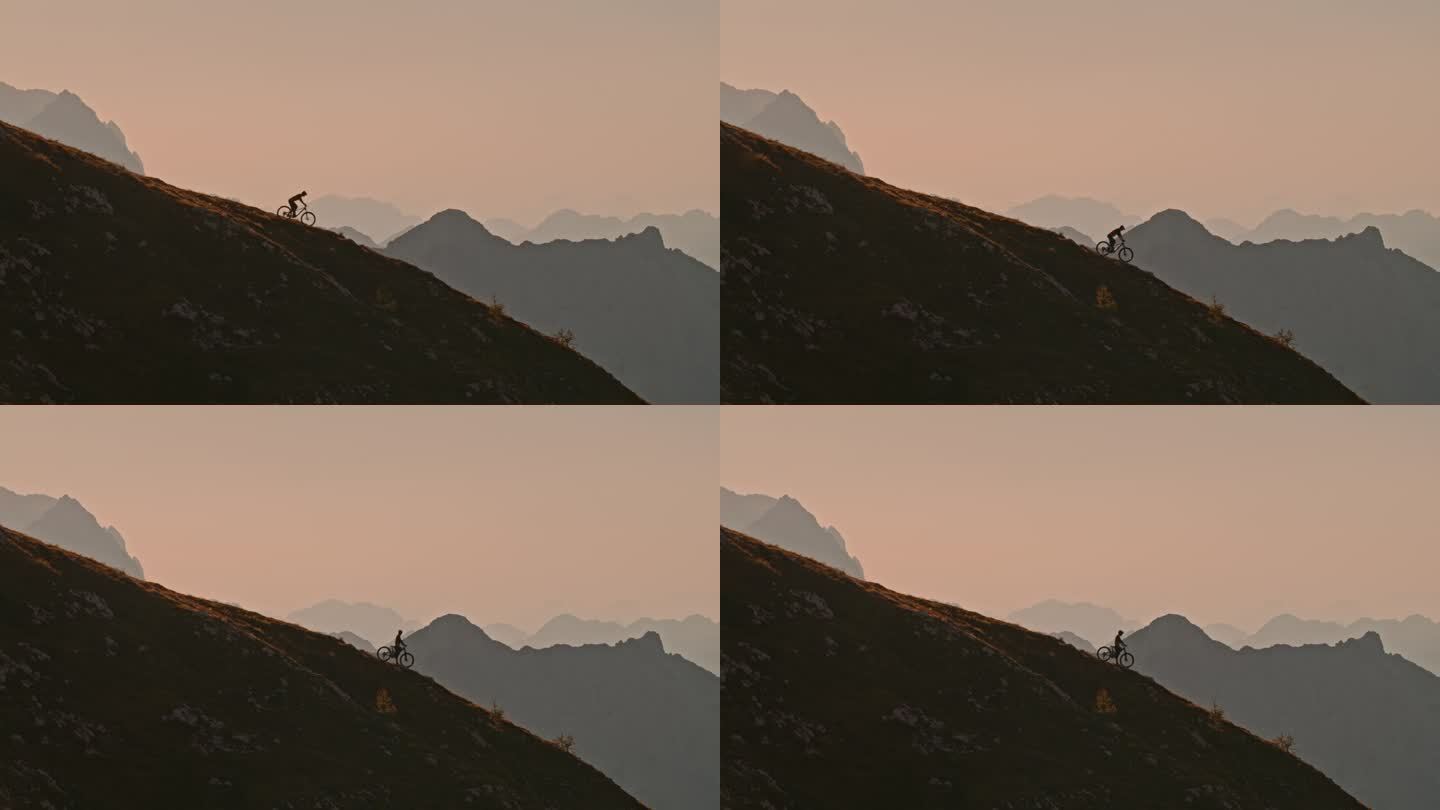 SLO MO锁定远镜头骑自行车的落基山对晴朗的天空在日落