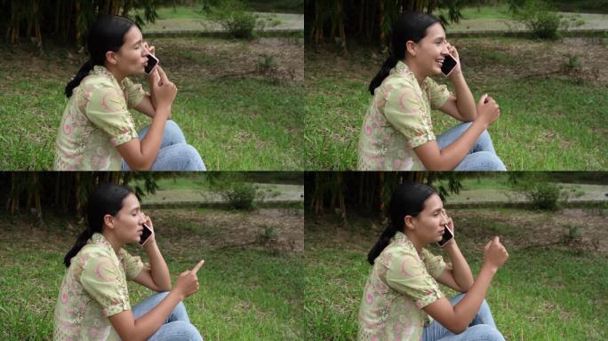 高画质视频，年轻女子在户外边讲电话边笑
