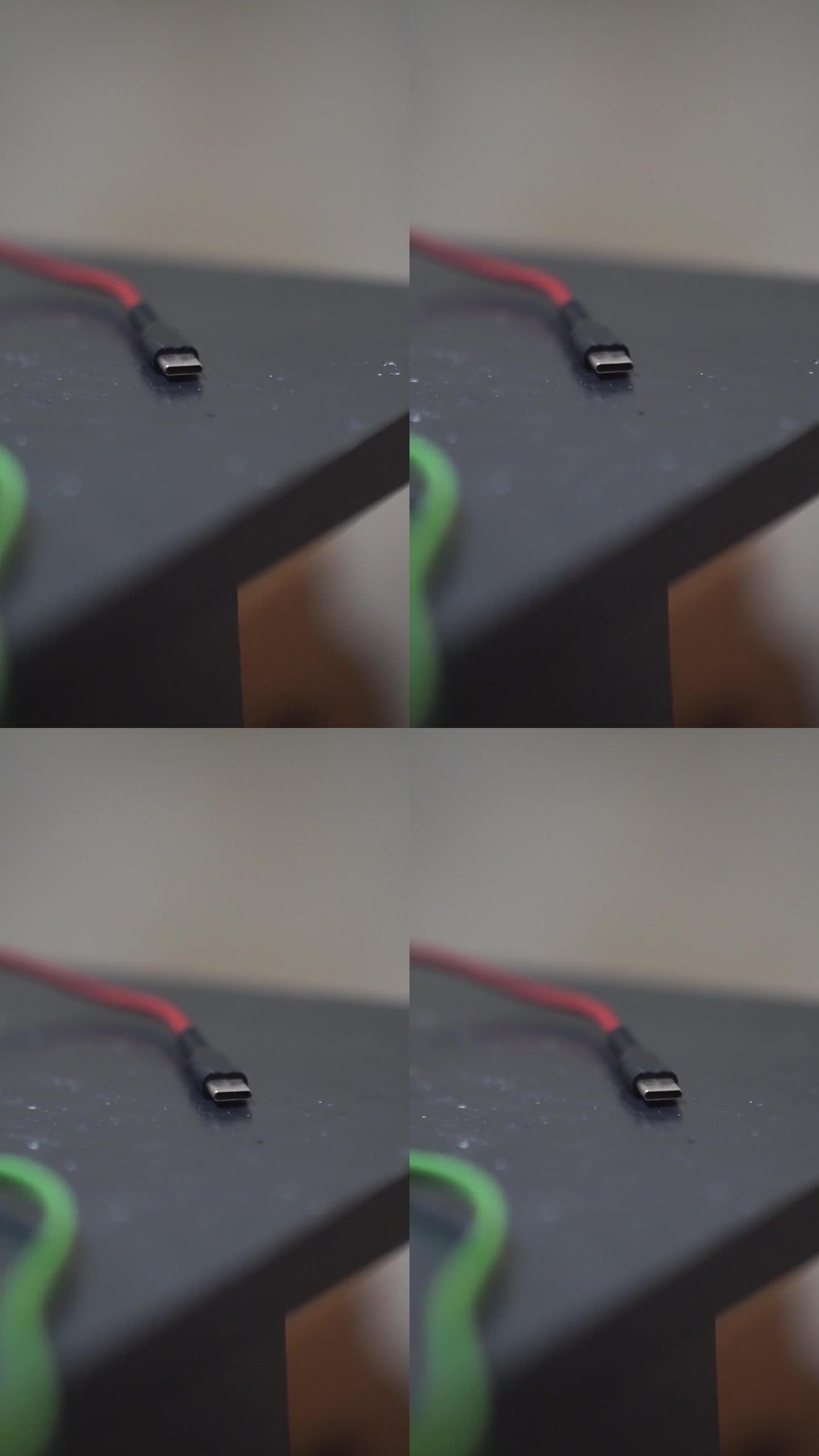 C型插头，红色电缆放在黑色的桌子上