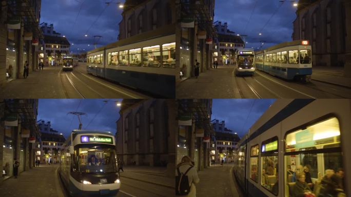 09/11/2023瑞士苏黎世。有轨电车抵达利马特奎老城区中心的车站。深夜的灯光，实时，行人游客的背