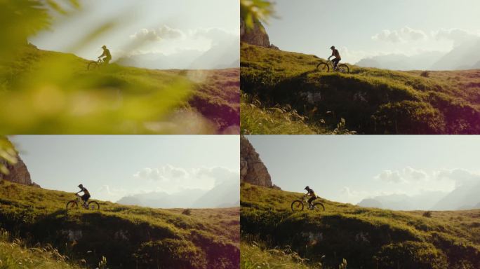 SLO手持拍摄的决心骑自行车的人在草山对天空在阳光明媚的一天