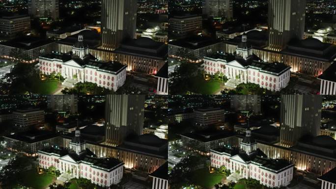 希腊复兴风格的佛罗里达州议会大厦矗立在佛罗里达州塔拉哈西市的夜景之上。航拍镜头采用宽平移相机运动。