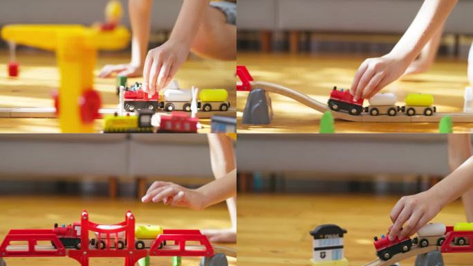 一个男孩在玩儿童玩具火车。孩子在地板上玩木制玩具。一辆玩具火车在木制的铁轨上行驶