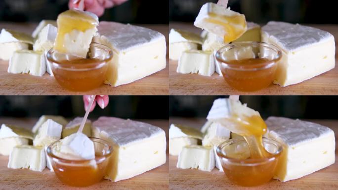 布里奶酪。卡蒙伯尔的奶酪。新鲜的布里干酪和一片放在木板上，配上坚果、蜂蜜和树叶。意大利奶酪，法国奶酪