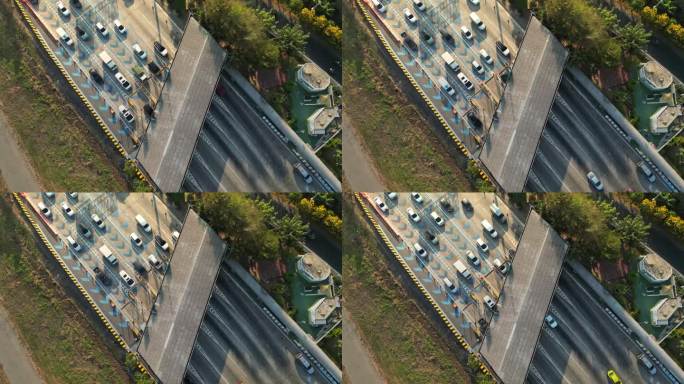 从空中俯瞰高速公路收费站，许多车辆在日出时经过