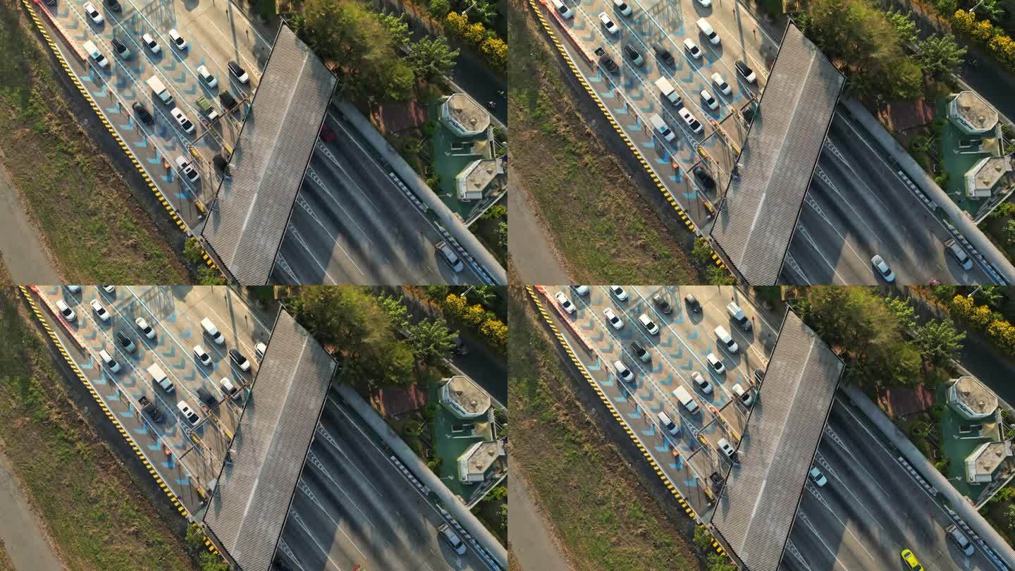 从空中俯瞰高速公路收费站，许多车辆在日出时经过
