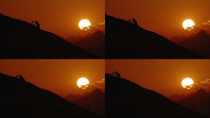 SLO手持拍摄的剪影山地自行车推动自行车上坡对戏剧性的橙色天空在日落