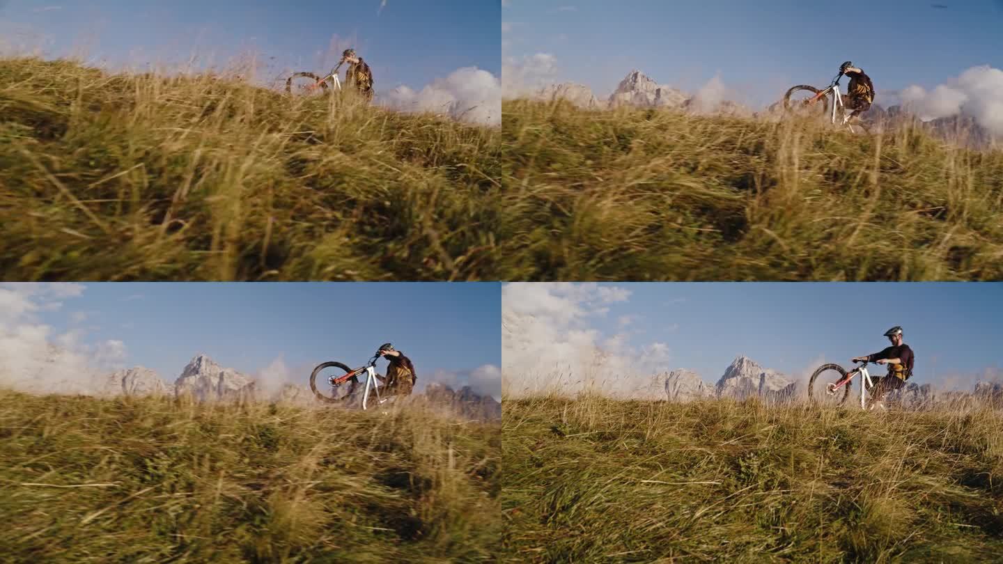 SLO MO的地面水平手持拍摄的决心骑自行车的车轮表演与自行车在草地上