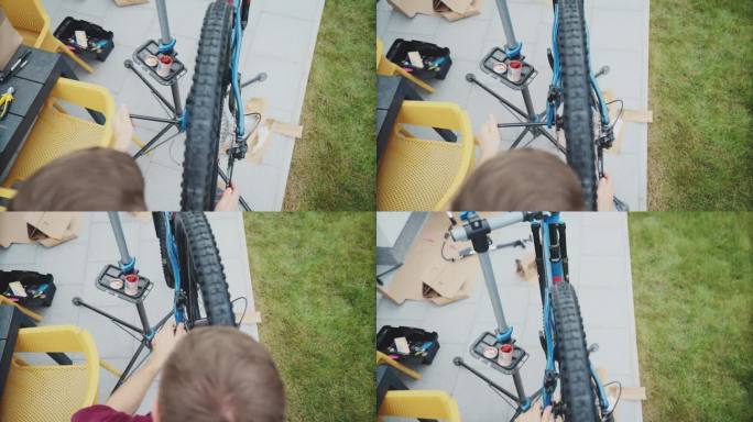 男子在院子里修理山地车新轮胎的SLO MO高角度手持镜头