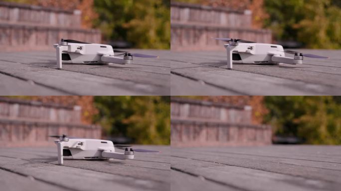 无人机在晴天从地面起飞。小型无人机特写，