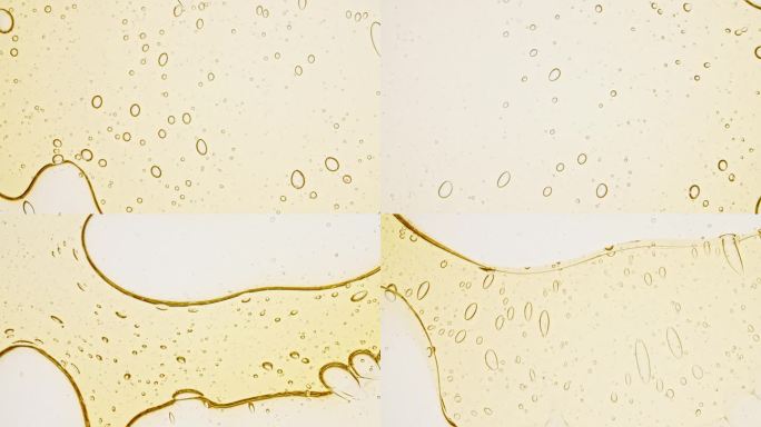 透明化妆品凝胶流体与分子气泡油分布。显微镜下的细胞泡簇。天然有机化妆品、药品微距拍摄。生产特写。缓慢