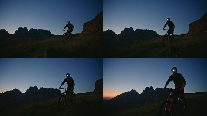SLO MO男性摩托车手戴着发光的头灯，在暮色中骑在草地上，对着清澈的蓝天