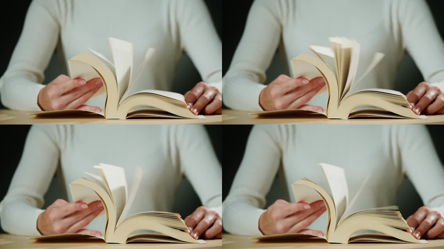 女人的手翻着西班牙语的书页，阅读和教育，翻看旧教科书。大学图书馆里的特写，微距镜头。