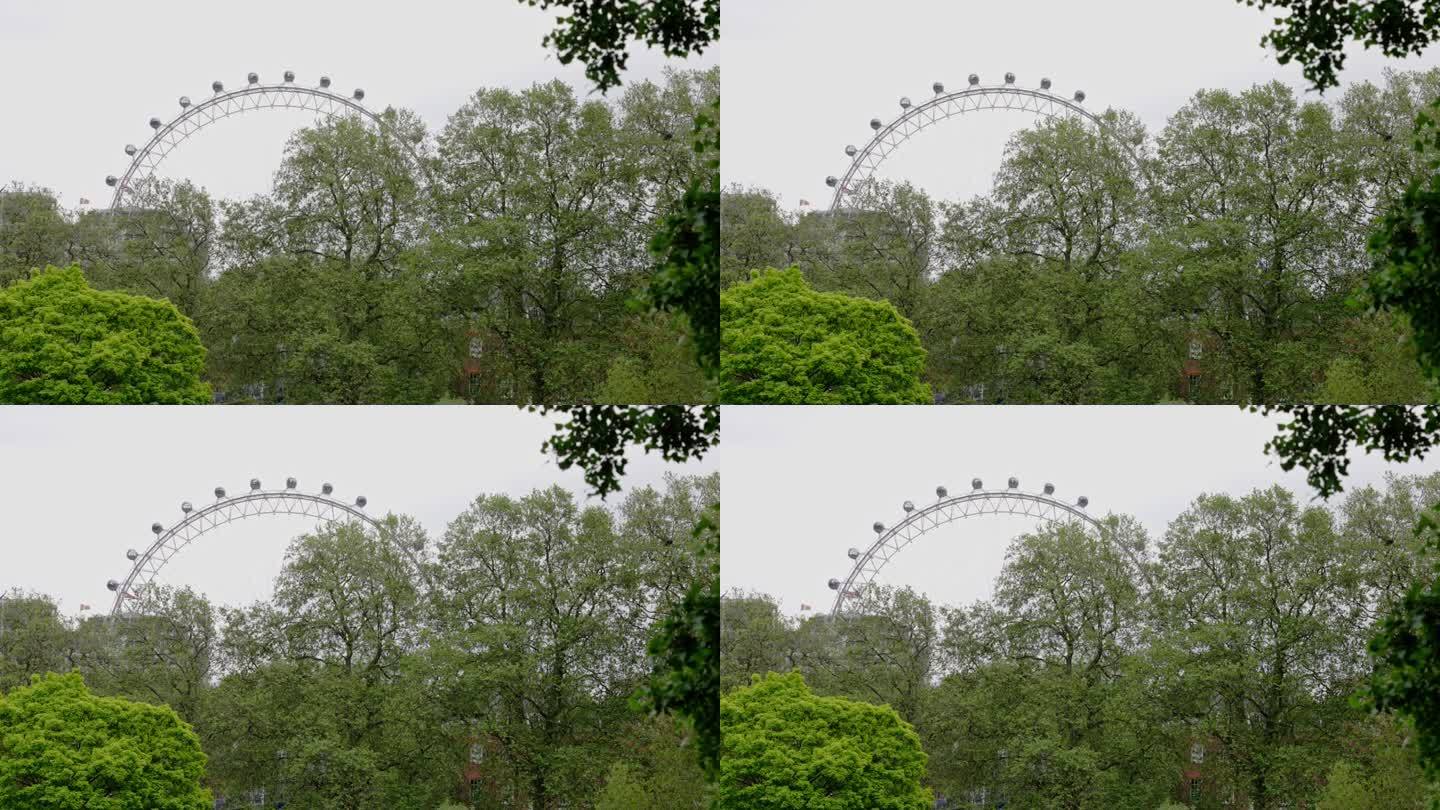 2023年5月22日，英国伦敦:伦敦威斯敏斯特圣詹姆斯公园，长镜头拍摄的伦敦眼缓缓移动