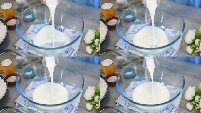 向碗中加入牛奶奶油。牛奶倒进碗里，特写。