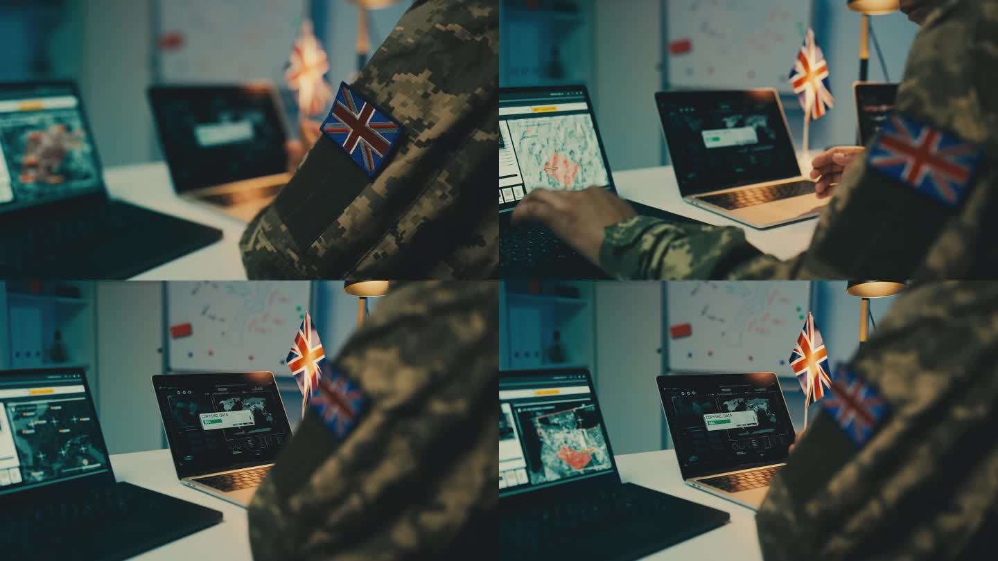 一名英国士兵正在用笔记本电脑复制收集到的情报