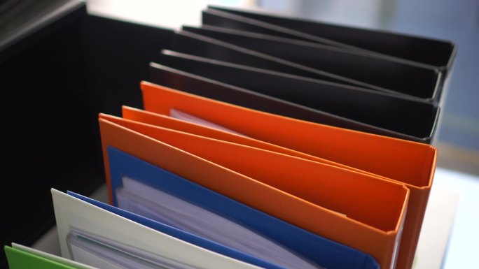 文件活页纸、办公桌上的橙色文件夹、办公室里的商业文件、金融市场年度报告文件、律师研究成果。概念工作努