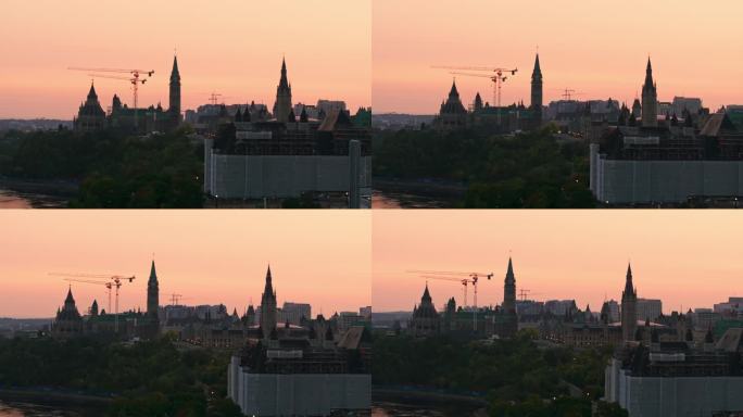 日出时分，一架无人机在渥太华河边拍摄的正在施工和翻新的加拿大最高法院和议会大楼