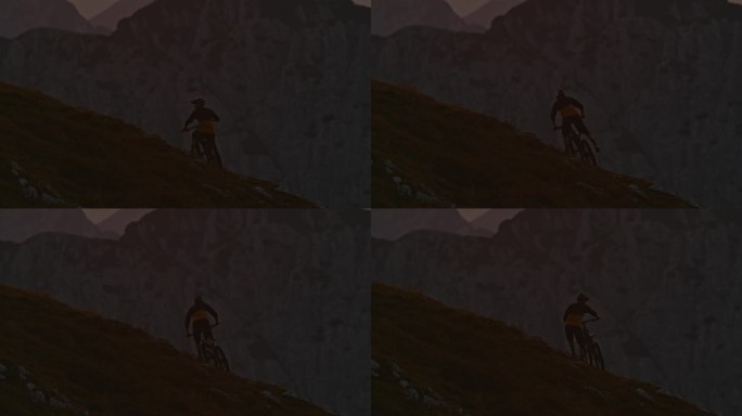 日落时分，男子山地自行车手扛着自行车在山上的SLO手持镜头