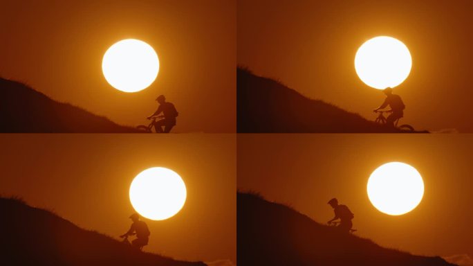 SLO MO剪影山骑自行车上山对雄伟的太阳在晴朗的天空在日落