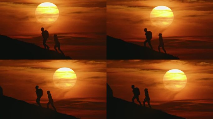 SLO - MO手持拍摄的剪影夫妇在日落时爬山对抗戏剧性的橙色天空