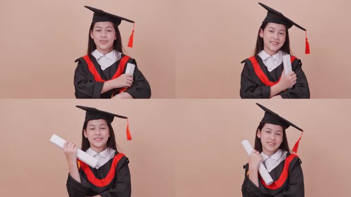 一个穿着毕业礼服的女学生做着快乐的手势和表情。孤立在褐色背景的工作室。